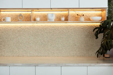 Stylish kitchen interior with modern cabinets and wooden countertop lights in a luxury new house....