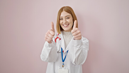 Young blonde woman doctor doing thumbs up over isolated pink background