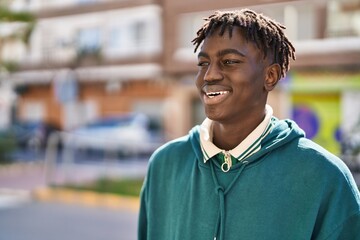 African american man smiling confident looking to the side at street