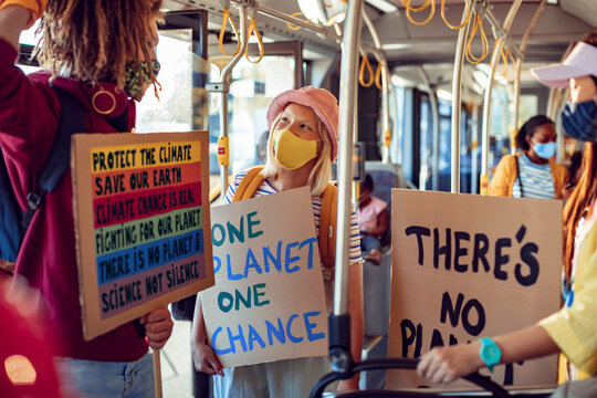 Diverse group of environmentalist going to a protest in the city on a bus