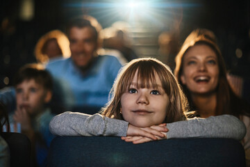 Young Caucasian girl watching a movie in the movie theater