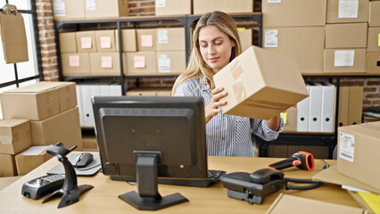 Young blonde woman ecommerce business worker scanning package at office