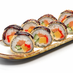 Deep-fried sushi roll with salmon, cucumber, cream cheese and crispy breadcrumbs. Warm tempura maki roll