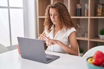 Young beautiful hispanic woman having video call communicate with sign deaf language at home