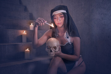 Young woman dressed for Halloween as nun with skull 
