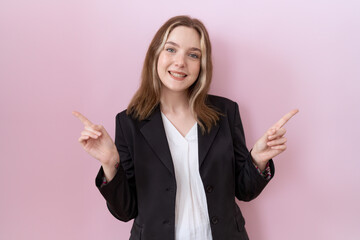 Young caucasian business woman wearing black jacket smiling confident pointing with fingers to different directions. copy space for advertisement