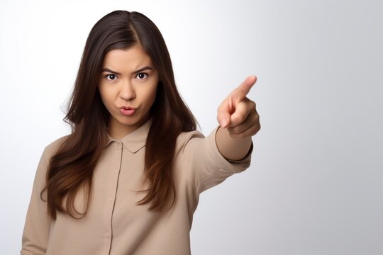 young woman with an angry gesture pointing her finger