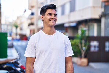 Fototapeta premium Young hispanic man smiling confident looking to the side at street