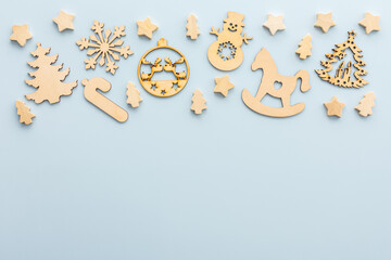 Natural wooden Christmas toys on a blue background, Merry Christmas and Happy New Year concept, top view, copy space