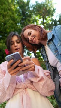 Collaborative dialogues between two fashion-forward and tech-savvy girls with smartphones in hand.