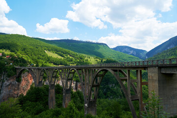 Famous Durdevica bridge in Montenegro. Long bridge over the deep canyon. Beauty mountains nature