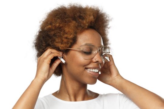 Smiling happy young african woman listening to music via wireless earphones with eyes closed