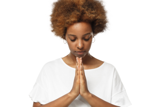 Close-up of young african woman putting hands together as if she is praying with closed eyes to find solution