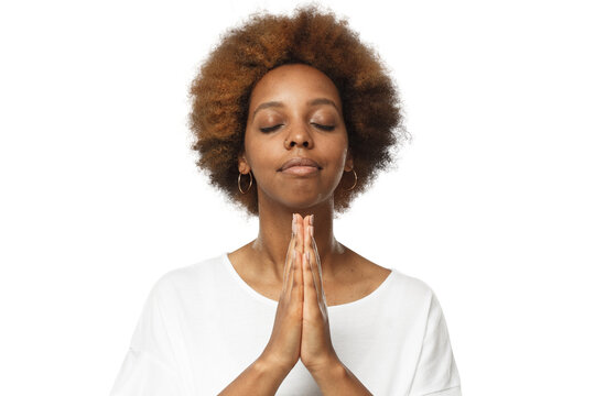 Close-up Of Young African Woman Putting Hands Together, Praying With Closed Eyes To Find Solution