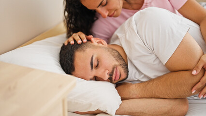 Obraz na płótnie Canvas Man and woman couple touching boyfriend head while sleep at bedroom