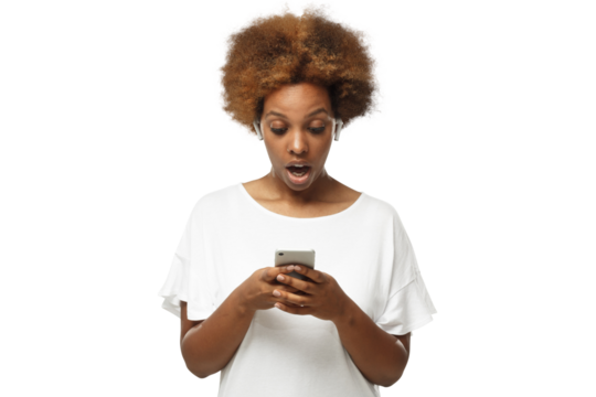 Portrait of african young woman holding phone, looking scared and confused reading text message