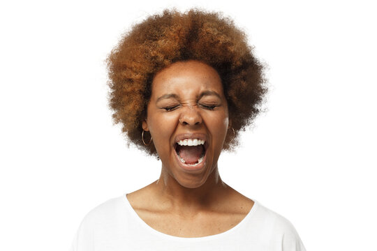 Close-up portrait of screaming with closed eyes crazy african american woman in blank white t-shirt