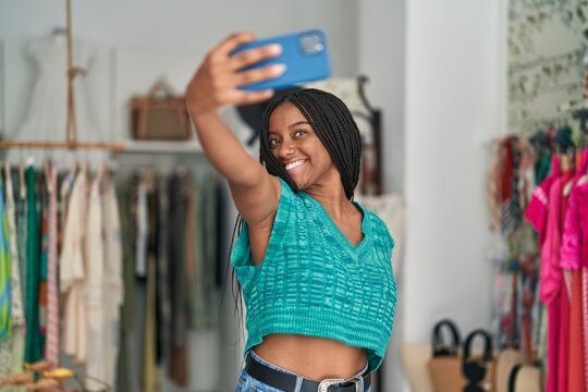 African american woman customer make selfie by smartphone at clothing store