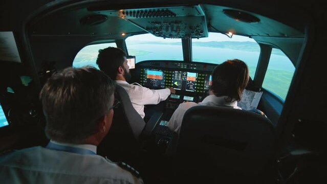 Instructor and pilots in professional flight simulator during flight