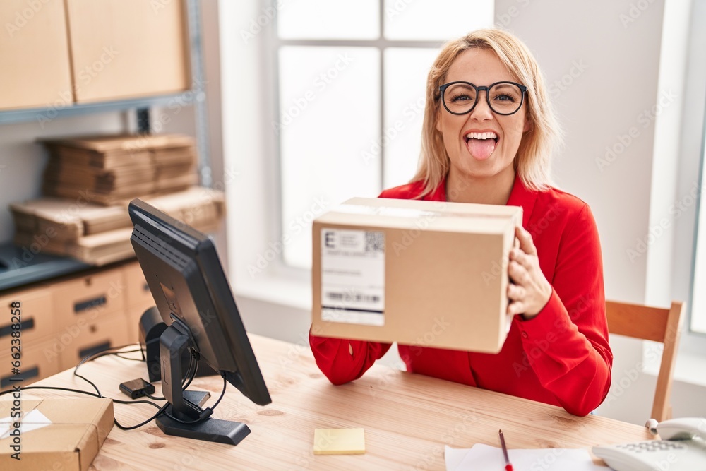 Canvas Prints blonde woman working at small business ecommerce holding box sticking tongue out happy with funny ex