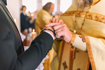 Holy wedding sacrament at the orthodox Christian church. Ring exchange ceremony between couples
