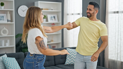 Man and woman couple dancing together at home