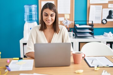 Young beautiful hispanic woman business worker using laptop working at office