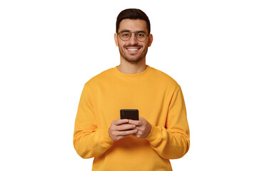 Young man wearing yellow sweatshirt, standing in front of camera with phone in hands
