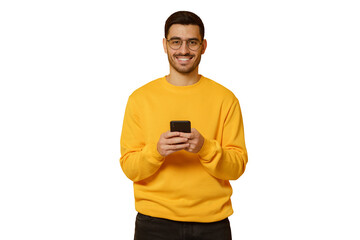 Young handsome man wearing yellow sweatshirt, standing in front of camera with phone in hands
