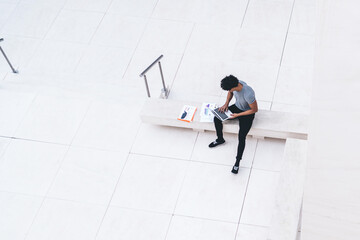 Male with laptop in light white hall