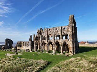 Whitby Abbey  7th-century Christian monastery that later became a Benedictine abbey. Whitby, Yorkshire seaside town   - obrazy, fototapety, plakaty