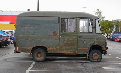 An old rusty green minibus is parked in the parking lot, Bolshevikov Avenue, St. Petersburg, Russia, October 12, 2023