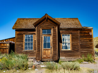 Old rustic wooden shack with blue sky above