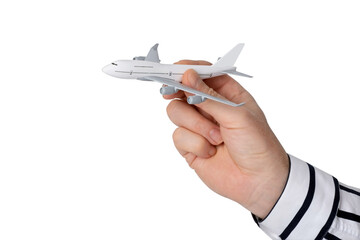 A man's hand in a classic shirt holds a model of a passenger airliner. Conceptual image. Isolated on a white background.