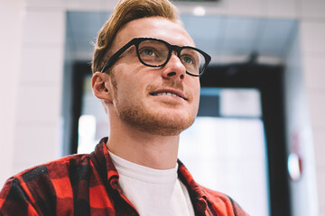 Calm man using smartphone for work at workspace