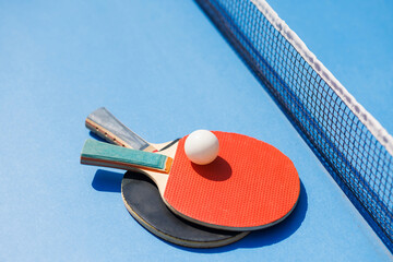 tennis rackets for playing ping pong on blue table, ping pong concept