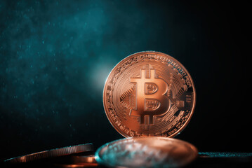 Technological coin Bitcoin on a black background in green smoke.