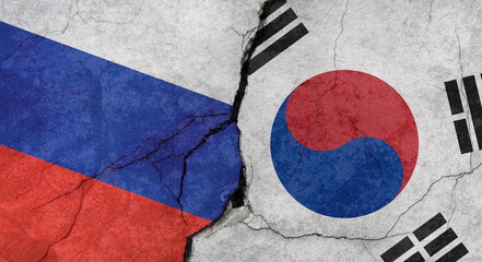 Russia and North Korea flags, concrete wall texture with cracks, grunge background, military conflict concept