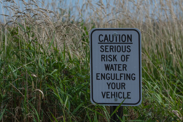 Caution Sign of Risk of Water Engulfing Your Vehicle.
