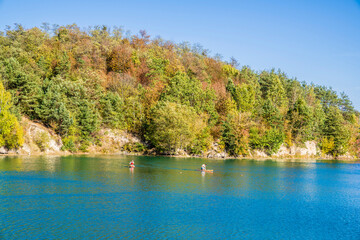 Lake autumn trees, sunny day blue sky.