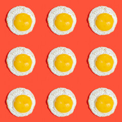 Seamless pattern with sunny side up egg on red background.