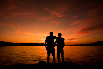 silhouette of two men at sunset, live yourself