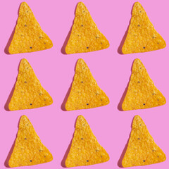 Seamless pattern with corn cheese nachos on pink background.