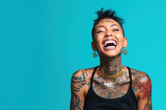 Young woman with neck and face tattoos happy smiling laughing