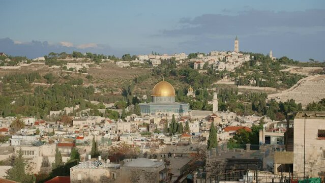 Dome of the Rock and Temple Mount in Old City of Jerusalem seen from far away. Famous Islamic shrine in the Al-Aqsa mosque compound seen in middle of other historic and holy sites in the ancient city