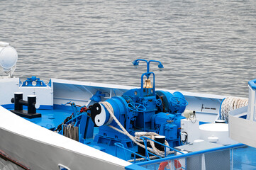 the bow of a large river ship. anchor control devices and ship's bell