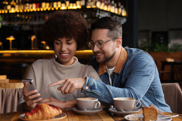 International dating. Happy couple spending time together in cafe