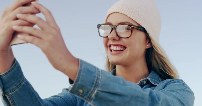 Woman, selfie and outdoor with glasses, kiss and excited with post, web blog and wind by sky background. Gen Z girl, student and pout lips with memory, photography and profile picture on social media
