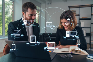 Thoughtful businesspeople typing on laptop at office workplace. Concept of team work, business education, internet surfing, brainstorm, project information technology. Social network hologram