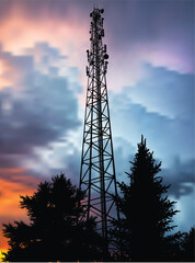 antenna tower silhouette in black forest at lilac sky background